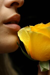 Person smelling flower