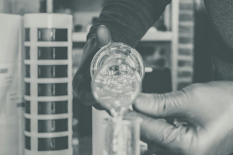 Perfumer pouring into beaker