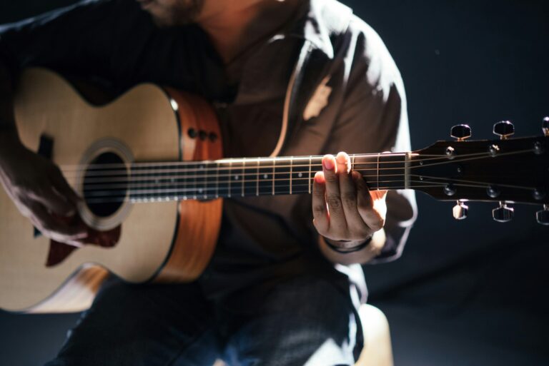 Man with Guitar on stool