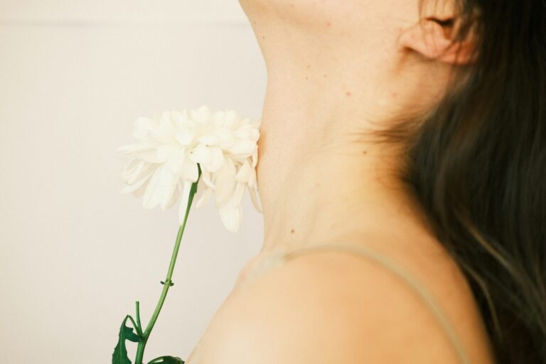 Woman with flower on her neck